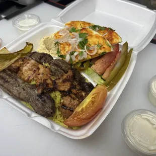 Mixed Grill lamb, chicken kebab and ground beef kebab with rice, hummus, 2 spice bread grilled vegetables and salad