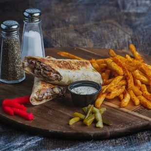 a sandwich and fries on a cutting board