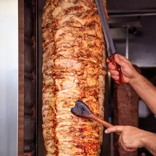 a man holding a large piece of meat