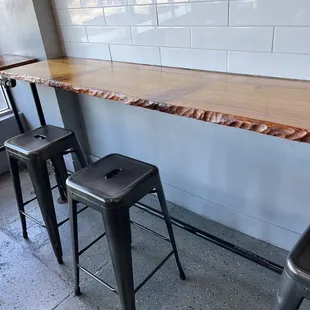 Beautiful life edge tables to sit, eat, and take in the outside bustle.