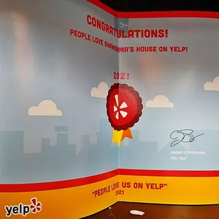 a red ribbon with a red rose on it