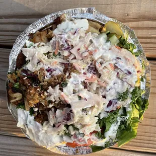 a bowl of salad on a wooden table