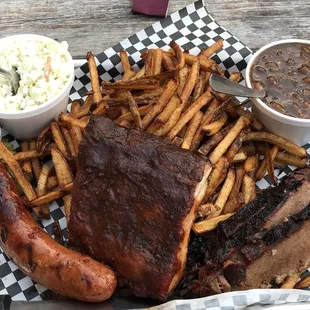 3 Meat Combo - ribs, brisket, hot link, with fresh cut fries, slaw, and bbq beans.  Yummy.