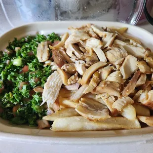 Chicken bowl with fries and tabulloue with the garlic sauce on the side (sauce not pictured).