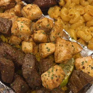 a tray of meat and macaroni and cheese