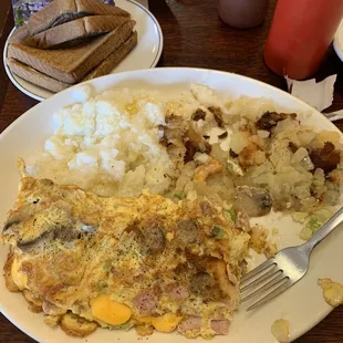 Meat omelette, grits, and home fries.