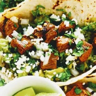 a plate of tacos and guacamole