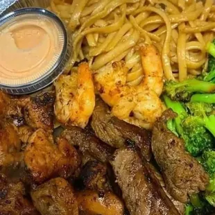 steak, shrimp, broccoli, and noodles