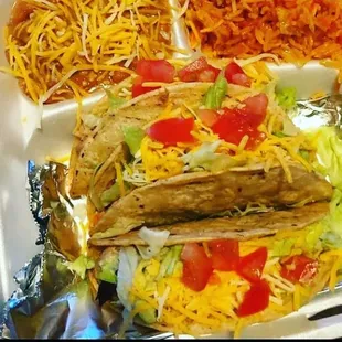 a plate of tacos and rice