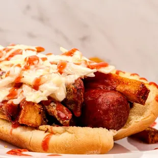 a hot dog on a bun with coleslaw