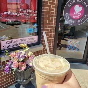 a hand holding a cup of coffee
