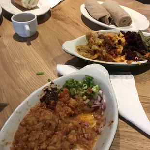Fava bean breakfast with sampler platter behind it