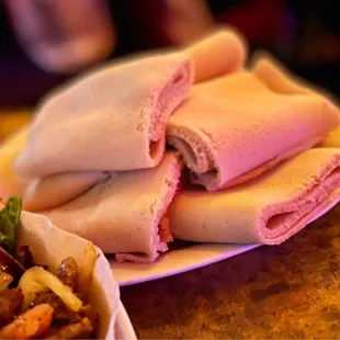 a plate of pita bread and a bowl of salad