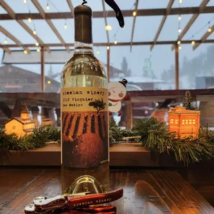 a bottle of wine and a corkscrew