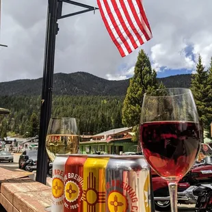 a glass of red wine and a can of beer