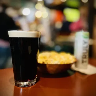 a glass of beer and a bowl of macaroni and cheese