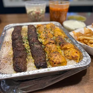 Family Meal with Beef Kubideh, Chicken Kabob, chickpeas, and chopped salad