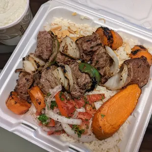 Shish kebab, medium rare, with grilled vegetables and rice. The garlic sauce side does not taste as good as it had in the past.