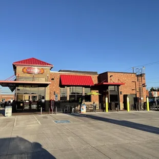 the outside of a restaurant with a red roof