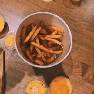 a bowl of french fries and orange juice