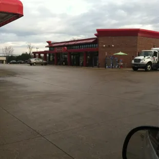 a view of a gas station from a car window