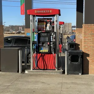 a red gas pump at a gas station