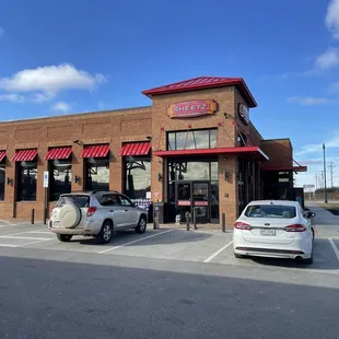 two cars parked in front of a restaurant