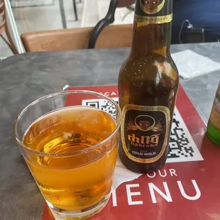a glass of beer and a bottle of beer