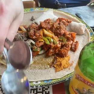 a plate of food and a bottle of beer