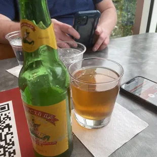 a bottle of beer and a glass of beer