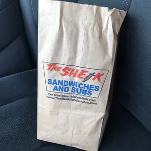a bag of sandwiches on the seat of a car