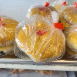 a variety of pastries wrapped in plastic