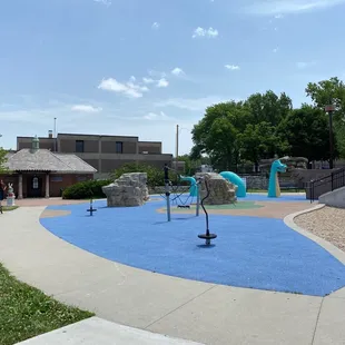 1/3 of the playground with bath house back left