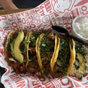 a tray of tacos and rice