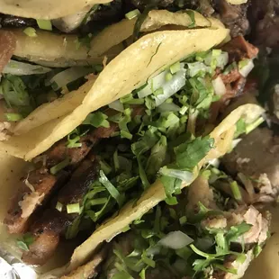 a plate of tacos with meat and vegetables
