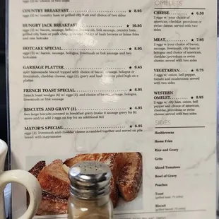 a breakfast menu and a cup of coffee