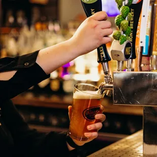 a woman pouring a beer