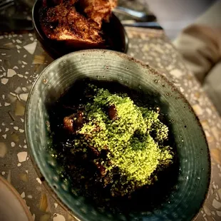 a bowl of broccoli and meat on a table