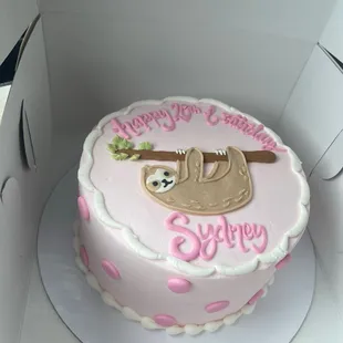 a pink and white cake with a baby slotty