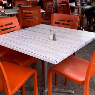 a table and orange chairs