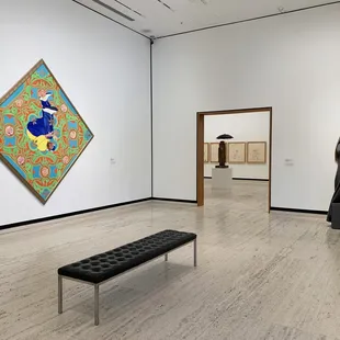 Works by (l to r) Kehinde Wiley, Jean Michel Basquiat, Marisol, and Judith Shea in "Person of Interest" at Sheldon Museum of Art, 2020.