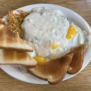 Chicken fried steak with three sunny side up eggs