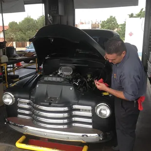 Checking the oil on a classic Chevy truck.