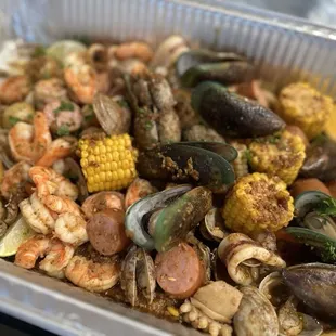 a tray of seafood and corn