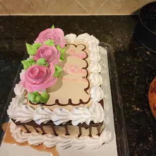 a chocolate cake with pink roses