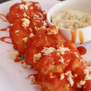 Buffalo Shrimp topped with blue cheese crumbs and blue cheese dip