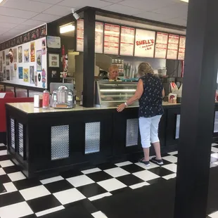 a woman standing at the counter