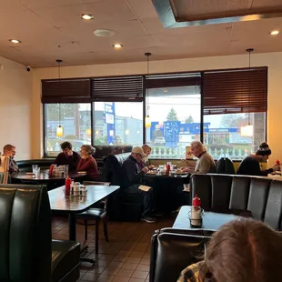 people sitting at tables in a restaurant