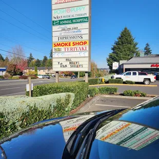 a car parked in front of a business sign