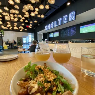 a bowl of food and a glass of beer